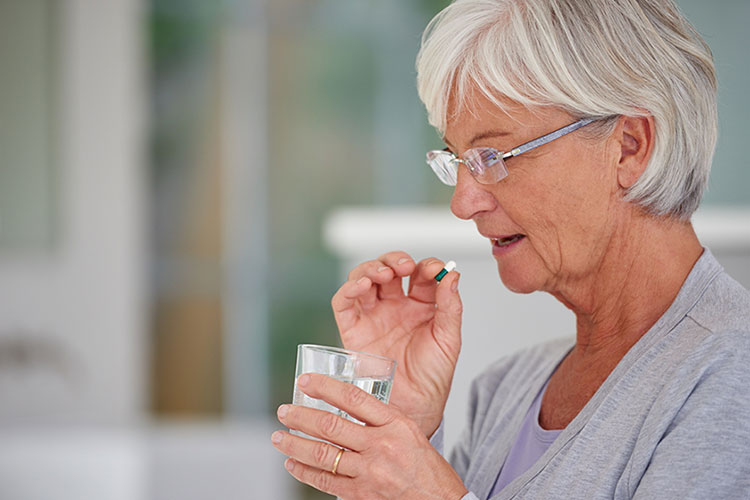 Old age patient taking pill